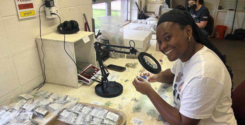 Trinity Jenkins works in archaeology lab